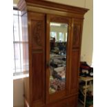 Edwardian satinwood wardrobe with bevelled mirror and carved decoration to front. Measures approx