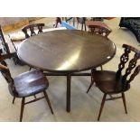 A dark wood Ercol drop leaf table & 4 old Colonial style chairs.