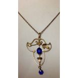 A Victorian gold pendant and chain set with 2 blue stones approx 4.0 total weight. Tests as 9ct.