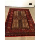 A vintage red & cream patterned wool rug /carpet. Approx 200 x 140cm - no fringing.