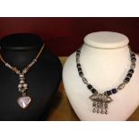 2 necklaces: 1 with silver & murano glass beads and 1 with black & blue beads and white metal