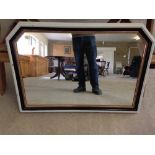 A white, black & bronze coloured overmantle mirror.