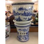 A chinese jardiniere with blue and white pagoda and lake scene