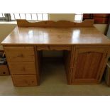 Pine 2 pillar desk with 3 drawers & a cupboard. Measures approx 142cm wide.