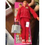An original 1970s boxed Six Million Dollar Man action doll with engine block in working condition.