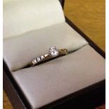 Hallmarked 9ct gold ladies ring with 0.25ct diamond and diamond set shoulders. Size L.