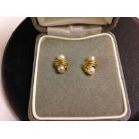 A pair of 9ct gold earrings set with pearls.