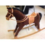 A childs brown plush rocking horse. Approx 79cm (31") tall to top of head and 60cm (24") floor to