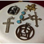 A collection of 6 pendants to include St. Christopher, crosses & an oriental symbol.