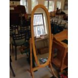 Light wood oval cheval mirror, 150cm tall.