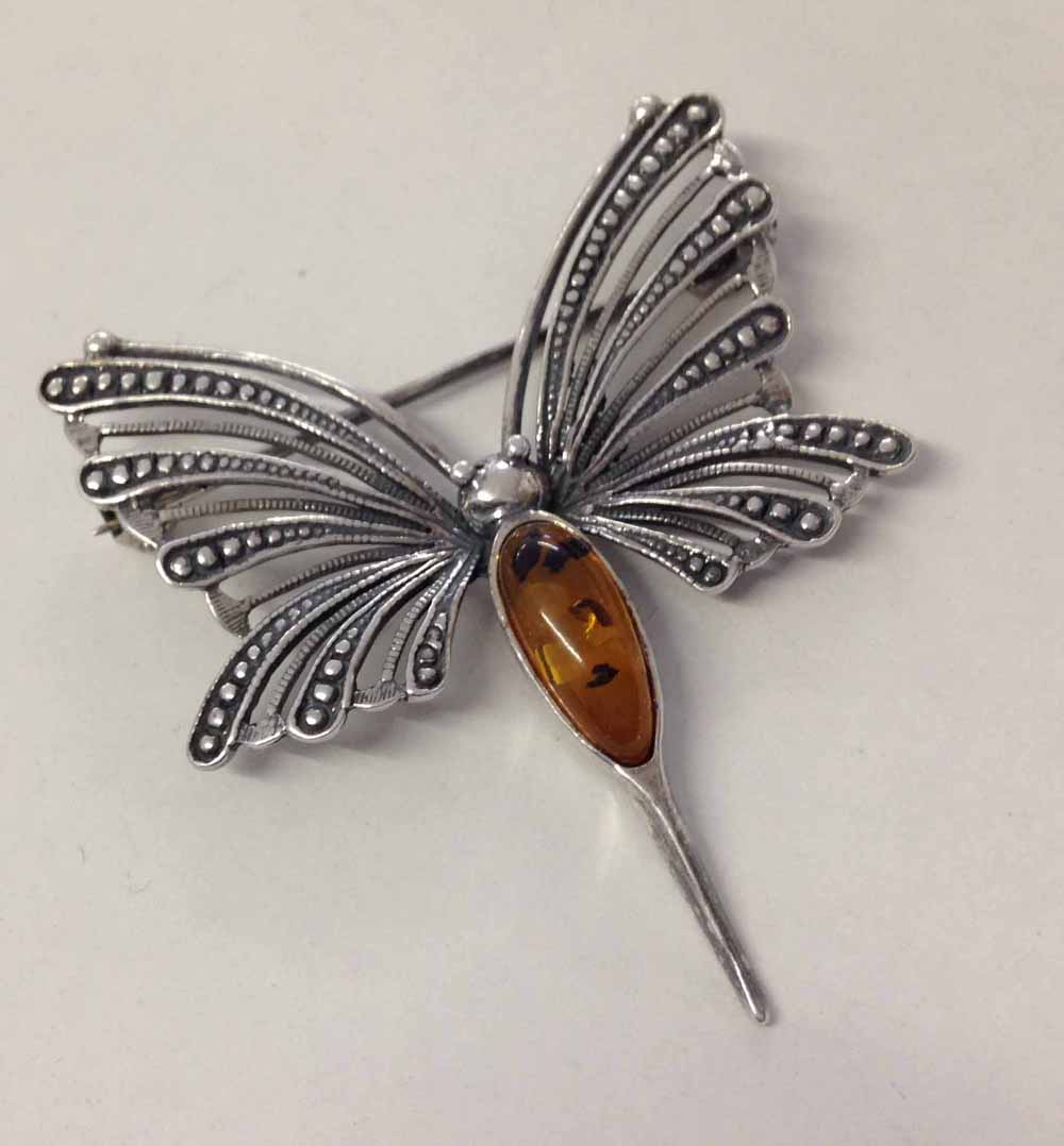 Silver 'Mayfly' brooch with oval amber cabouchon.