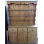 A pine dresser approx 138cm wide, 200cm tall & 46cm deep.