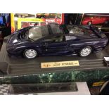 A boxed Maisto 1:12 scale Jaguar XJ220 (1992) in blue.