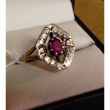 9ct gold ring set with oval ruby with a diamond shaped mount set with small white stones. Weight