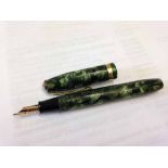 A Conway Stewart 84 fountain pen in green marble with 14ct gold nib.