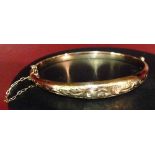 A 9ct rose gold ladies bangle, HM Birmingham 1920, with engraved design, approx 7g.