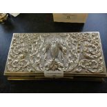 A Thai white metal possibly silver cigarette box with elephant & goddess decoration.