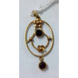 A 9ct gold Victorian pendant set with 2 garnets.