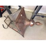 A vintage copper street lantern in need of replacement glass.