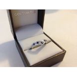 Hallmarked 9ct white gold V shaped ring set with blue & white sapphires. Size approx O