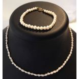 A freshwater pearl necklace and a pearl bracelet.