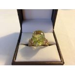 Hallmarked 9ct gold ring set with a large oval citrine nicely cut with many facets. Pierced mounts