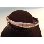 A 9ct rose gold ladies bangle, HM Birmingham 1920, with engraved design, approx 7g.