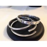 3 heavy silver bangles total weight approx 84gm - one has a small stone missing.