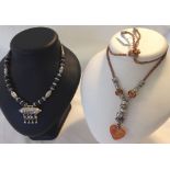 2 necklaces: 1 with silver & murano glass beads and 1 with black & blue beads and white metal