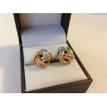 A pair of tri-colour 9ct gold 'knot' design earrings. Approx weight 2.8gm