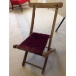 An old wooden childs folding chair, approx 60cm tall.