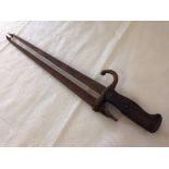 A pair of fireside tongs made from an old French bayonet