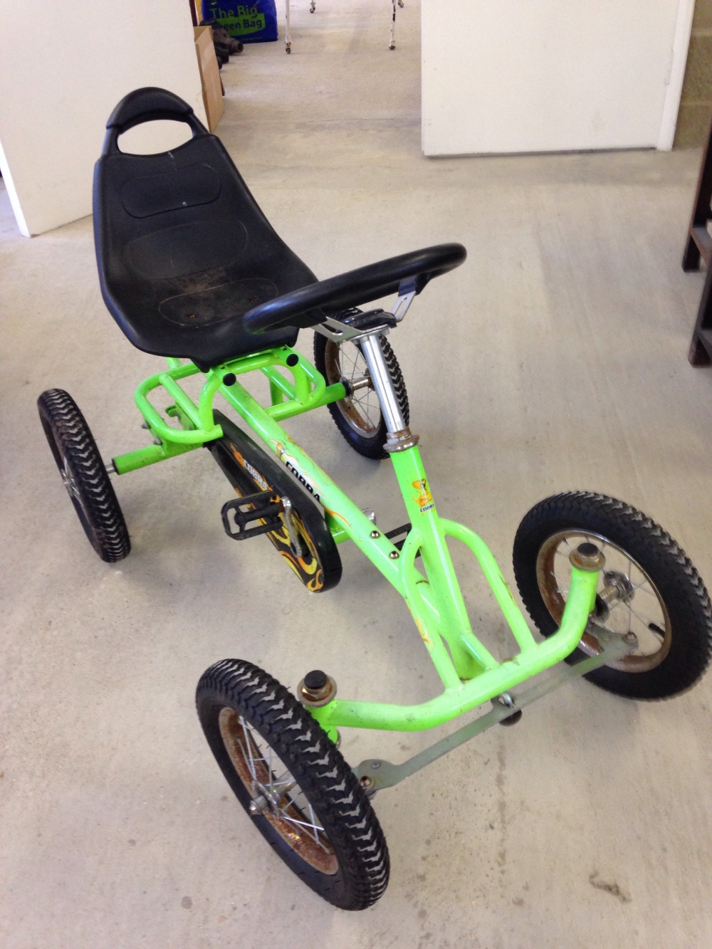A childs 'Cobra' fluorescent green pedal go-kart