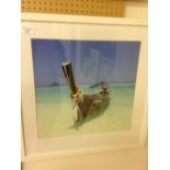 A large framed & glazed print of a tropical boat & beach scene. 58 x 58cm.