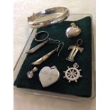 A small tray of silver jewellery including a locket engraved 'With love X'.