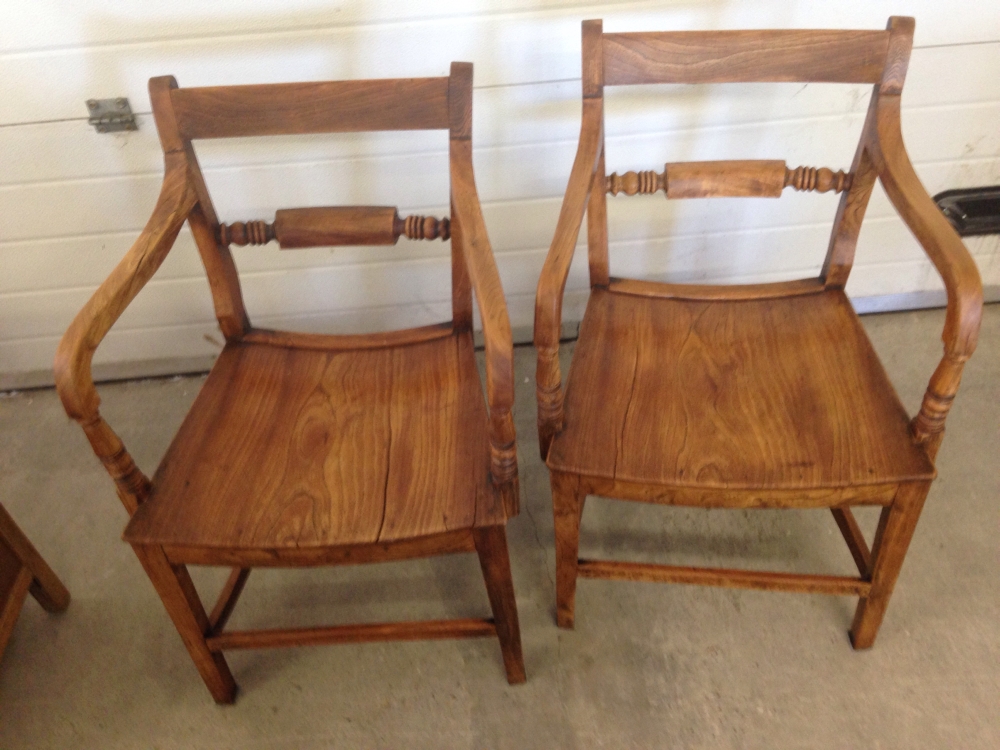A pair of antique oak chairs.