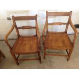 A pair of antique oak chairs.