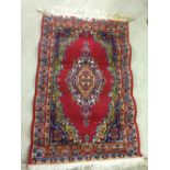 A small red rug/mat. 60 x 100cm.