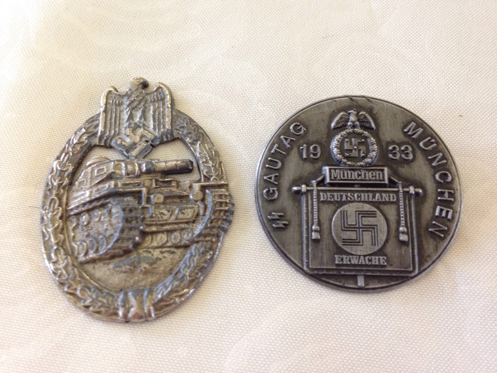 2 German military badges: a 1933 Munich Nazi 'tinnie' and a tank badge.