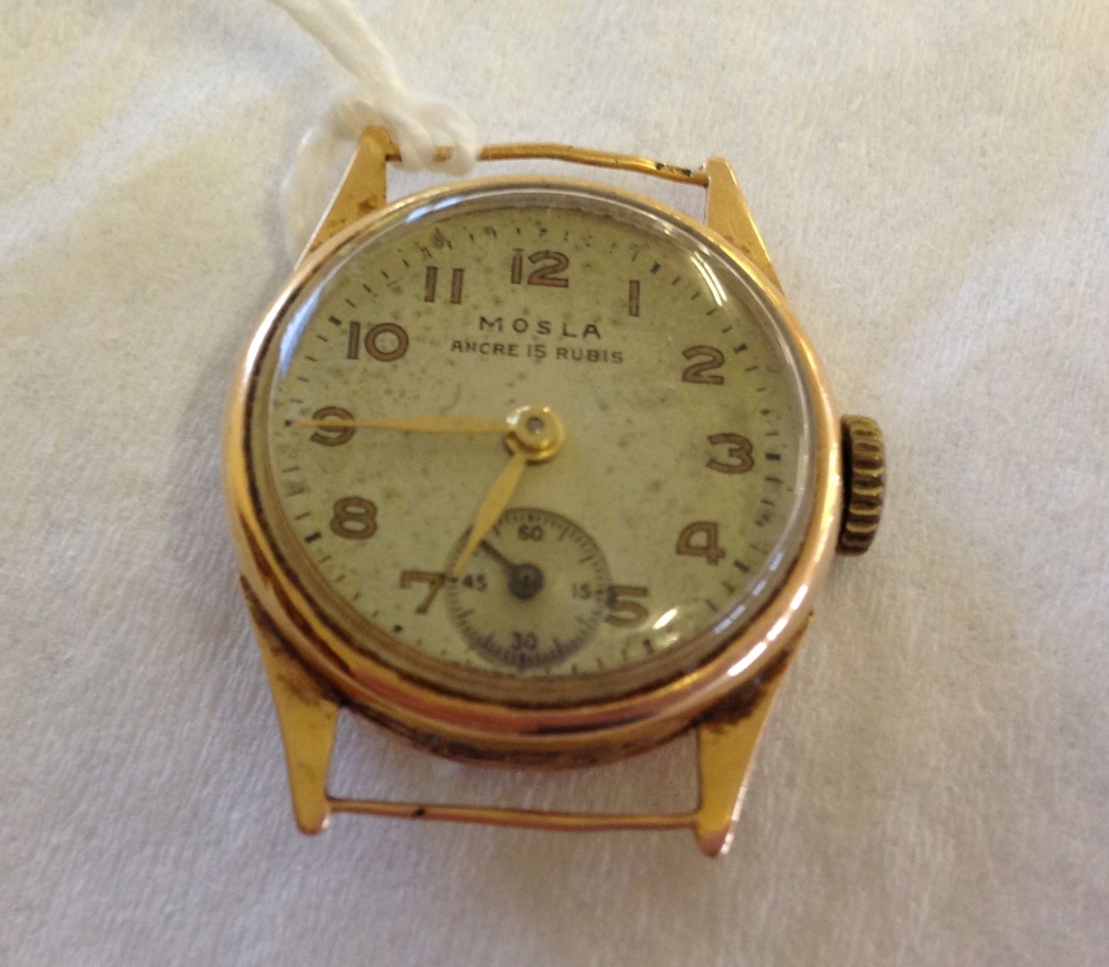 A Mosla ladies 18ct gold watch with 15 rubies in working order. Total watch weight approx 8.4g.