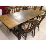 An oak dining room table with extending leaves & 4 chairs - table 182cm long when extended.