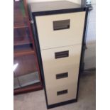 A 4 drawer metal filing cabinet.