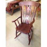 A modern wooden farmhouse rocking chair.