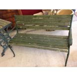 A garden bench with green cast iron ends and wooden slats. 122cm wide.