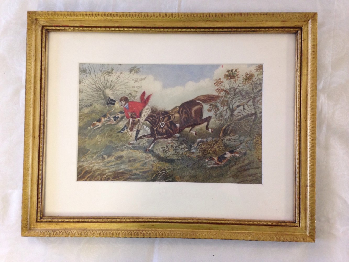 A framed & glazed watercolour of a Regency Huntsman being un-horsed. 34 x 43cm. Unsigned.