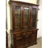 An oak sideboard/display cabinet with lead light glass.