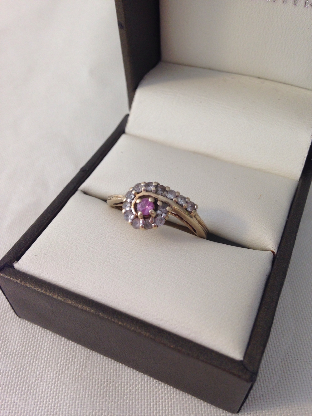 Hallmarked 9ct gold ladies dress ring set with a central pink sapphire surrounded by white, size