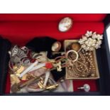 A black jewellery box containing costume jewellery & other items to include cameo brooch & choker,