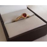 9ct gold ring with central heart shaped garnet. Size N.