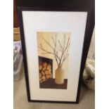 A framed & glazed print of logs, a vase and twigs. 95 x 55cm.